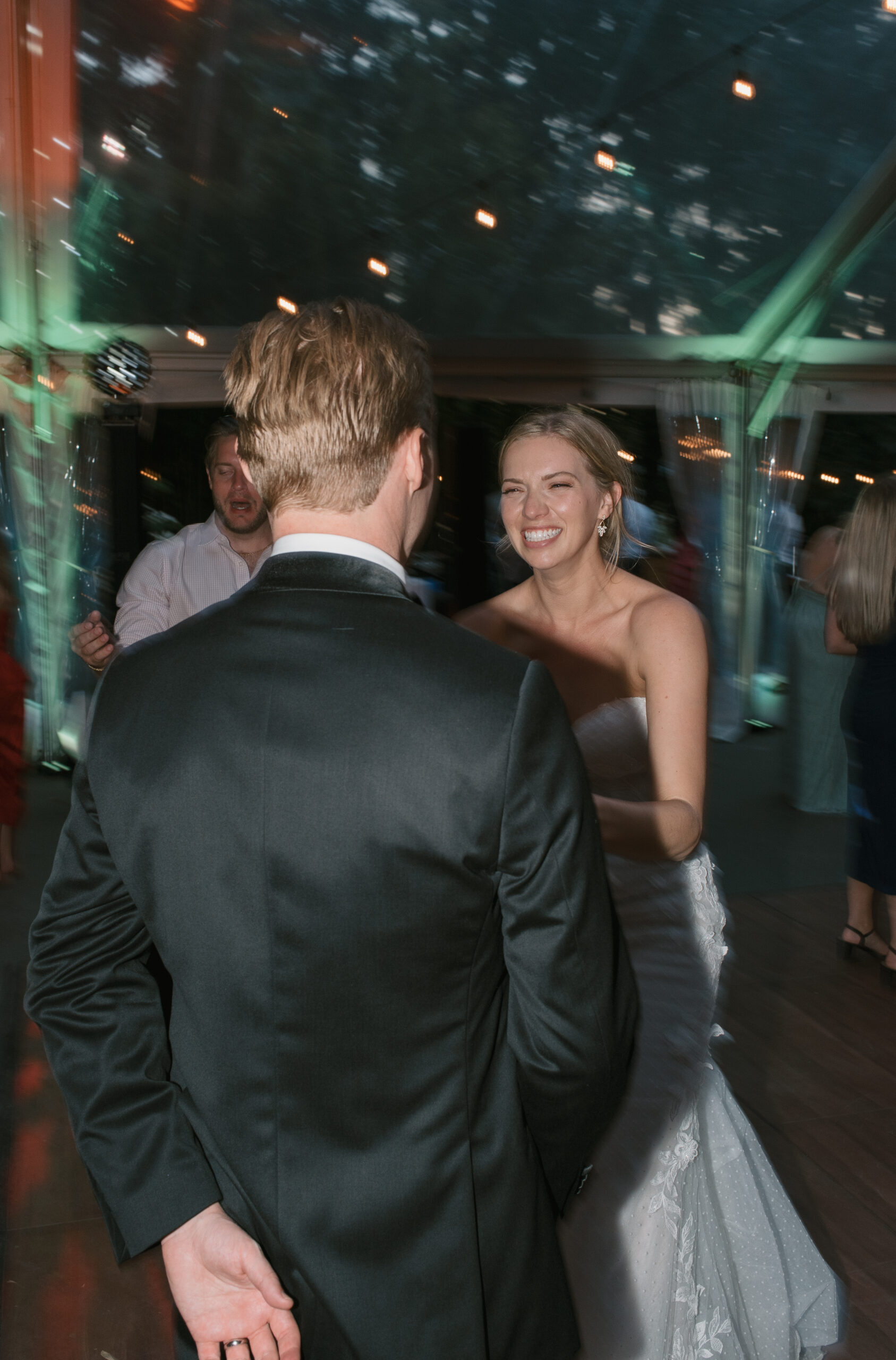 bride and groom laughing with each other while on the dance floor