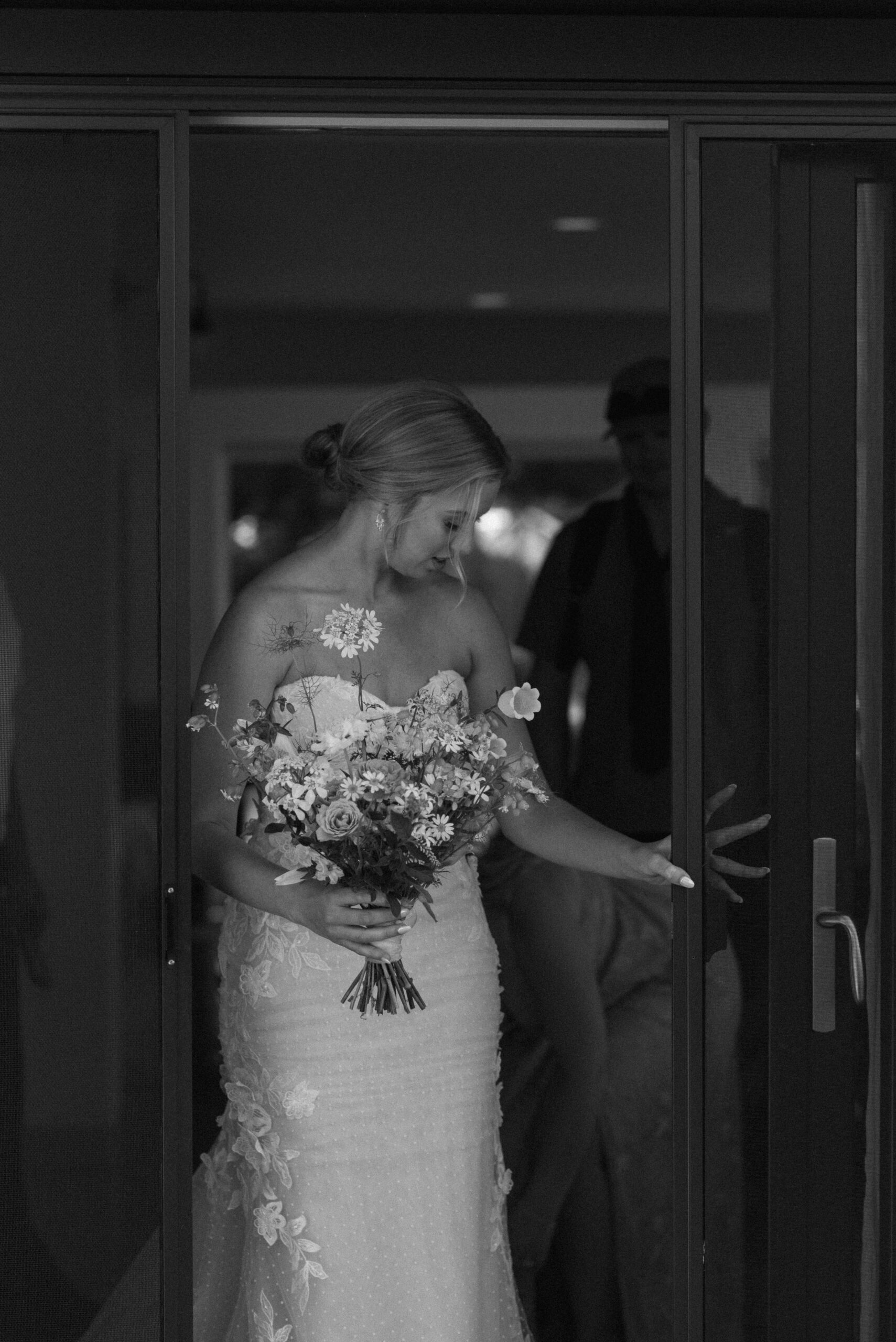 Black and white photo of bride in doorway at The Griffin Hosue