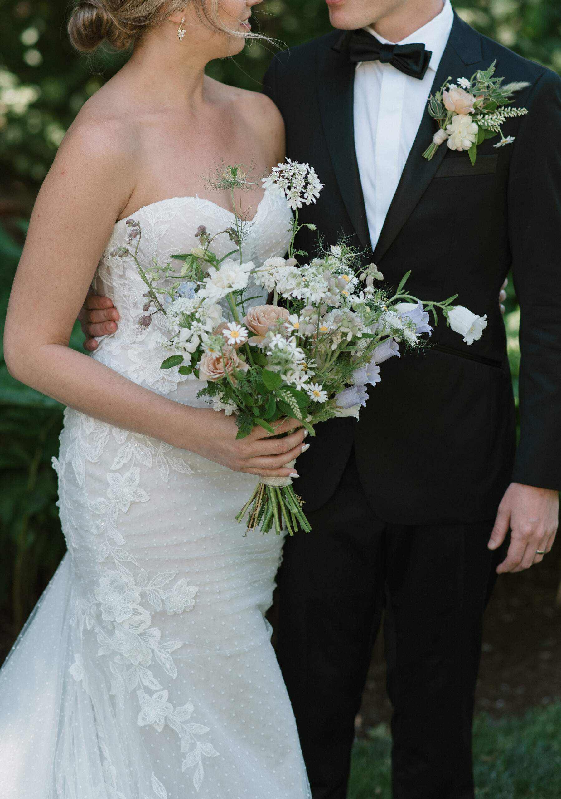 an editorial close of up the bride and groom's attire