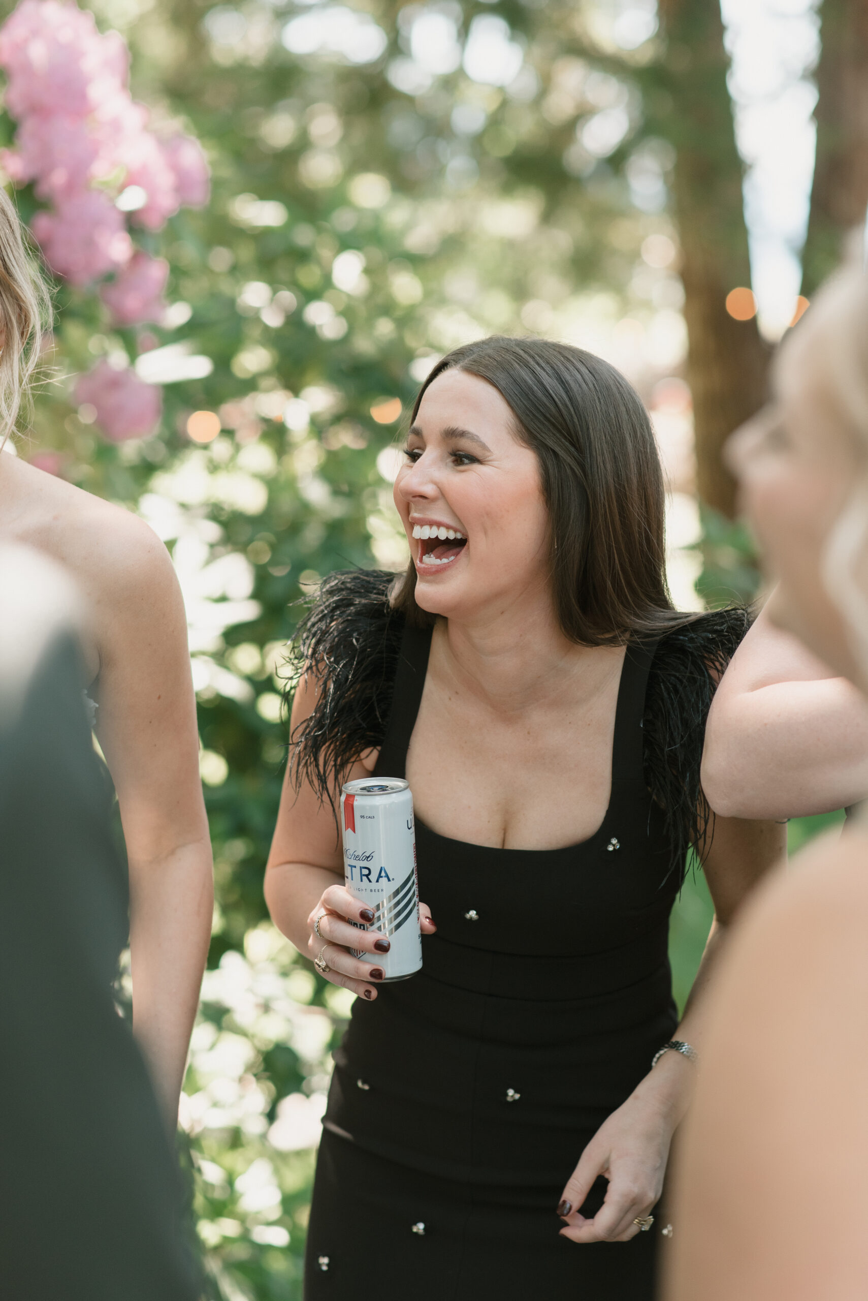 A close friend laughing while chatting with the bride at The Griffin House