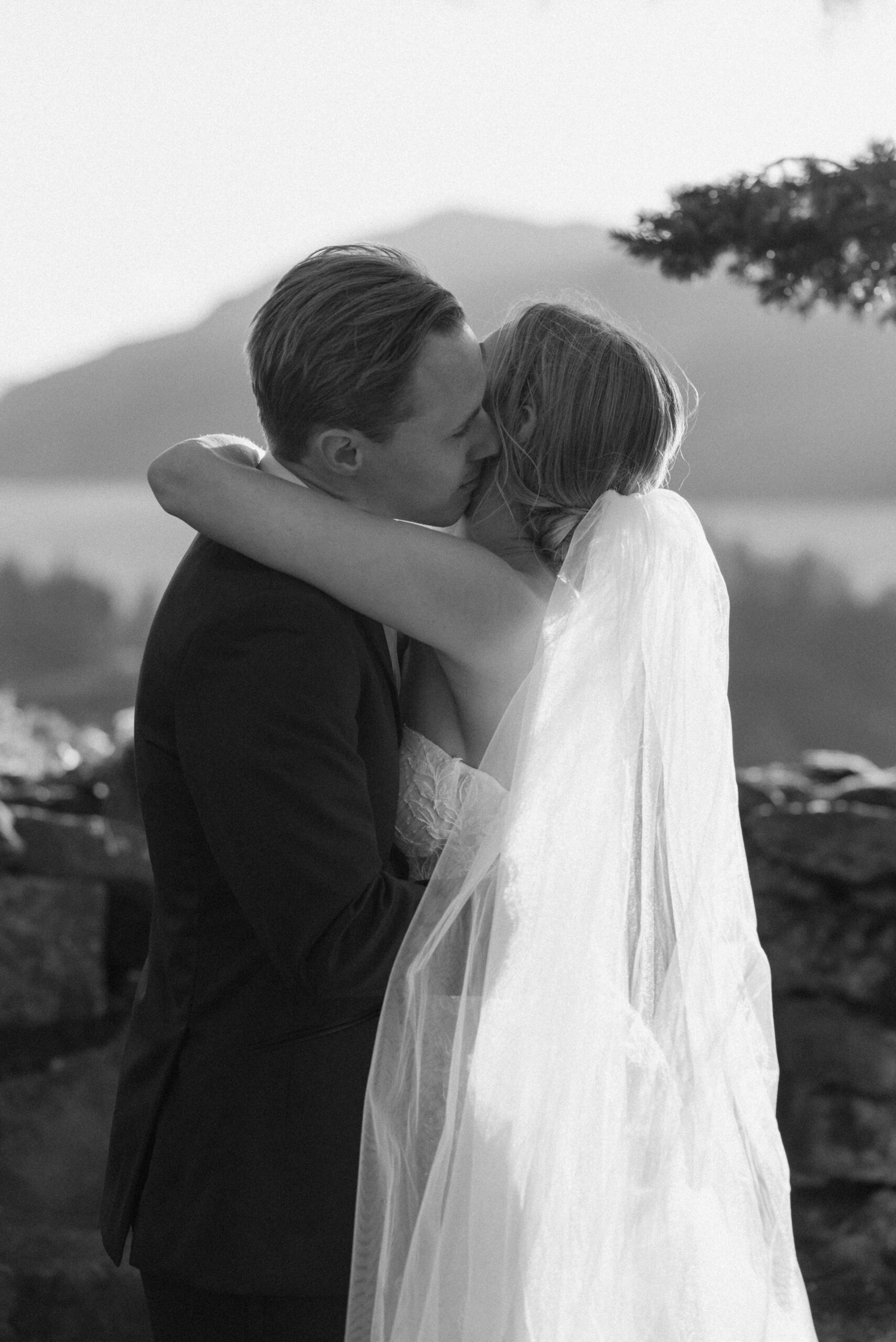 a black and white photo of the couple embracing at the griffin house