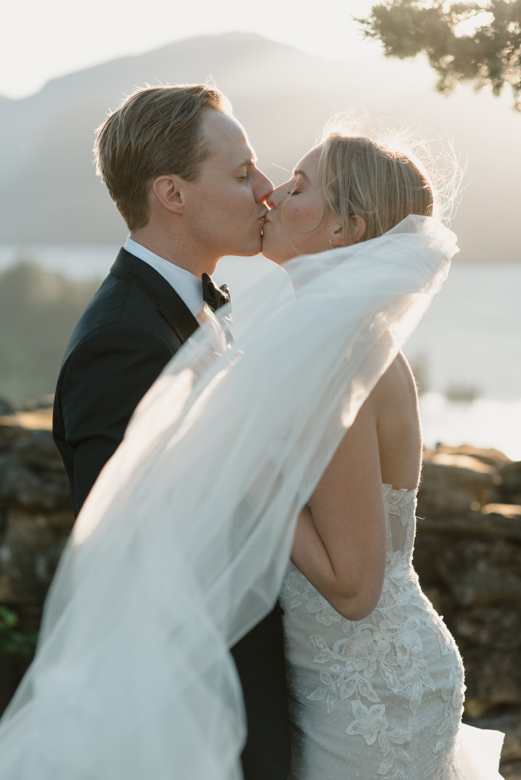 the couple kissing at sunset