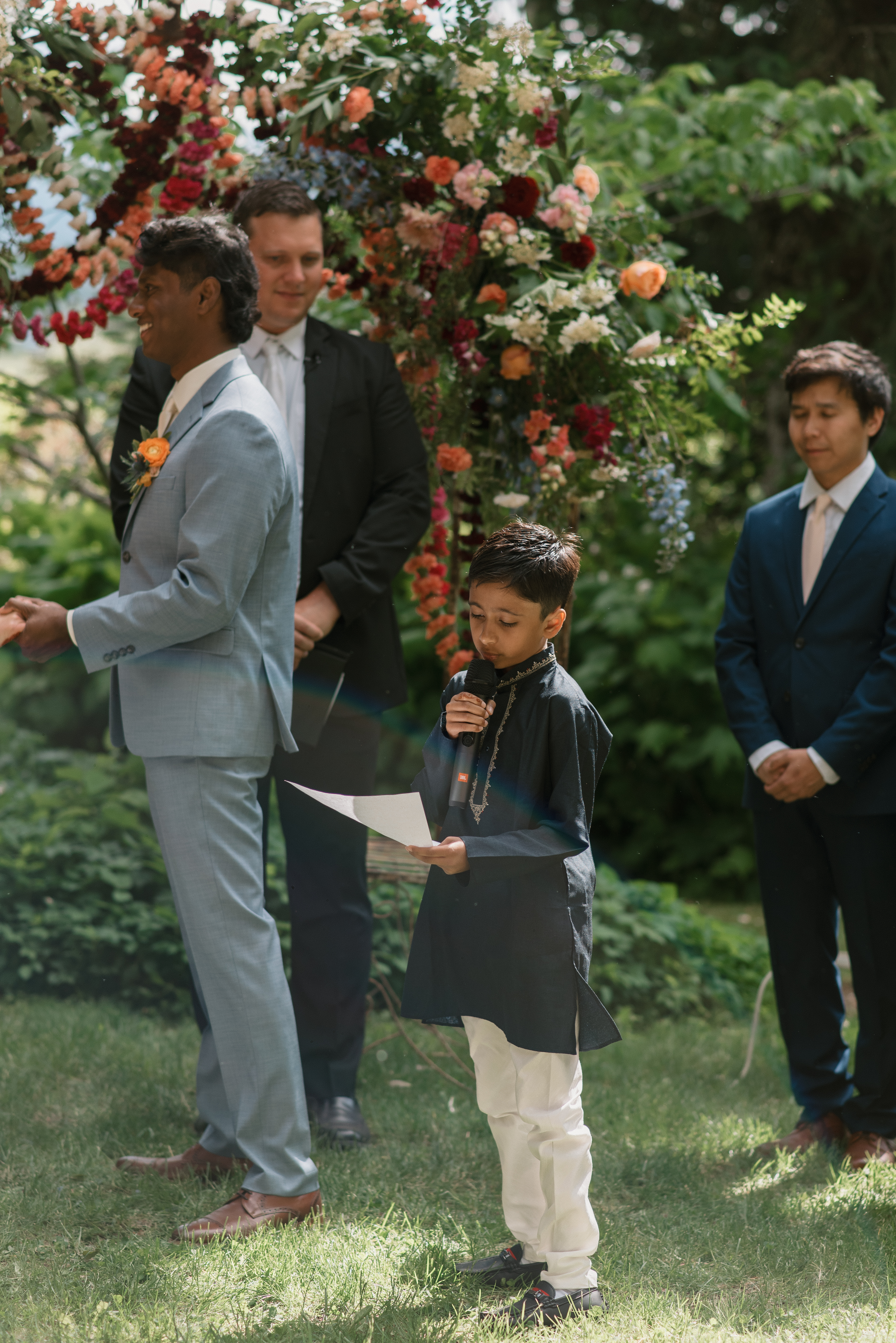 grooms young cousin reading a passage at the ceremony of a mt hood organic farms wedding