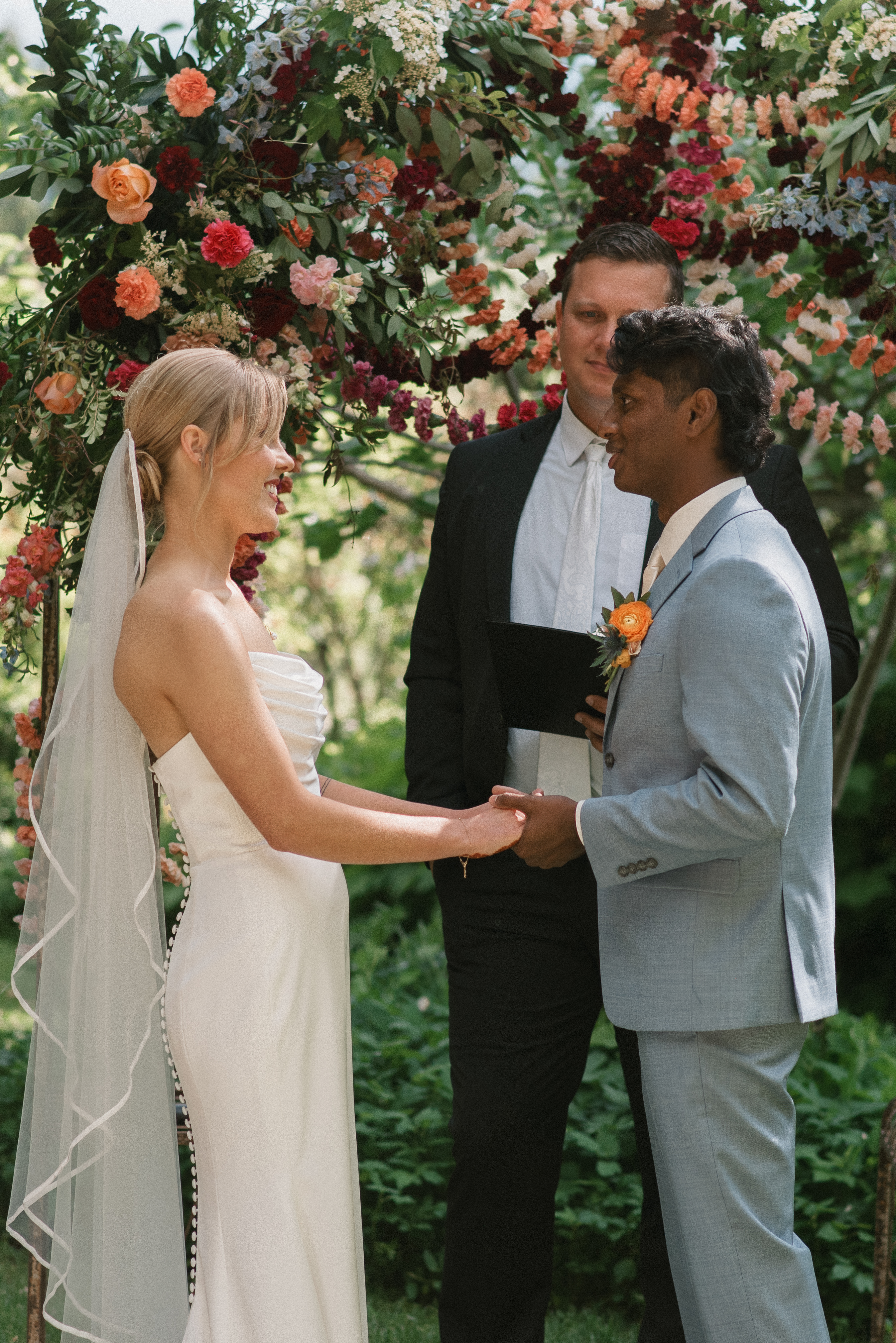 bride and groom exchanging vows at their ceremony