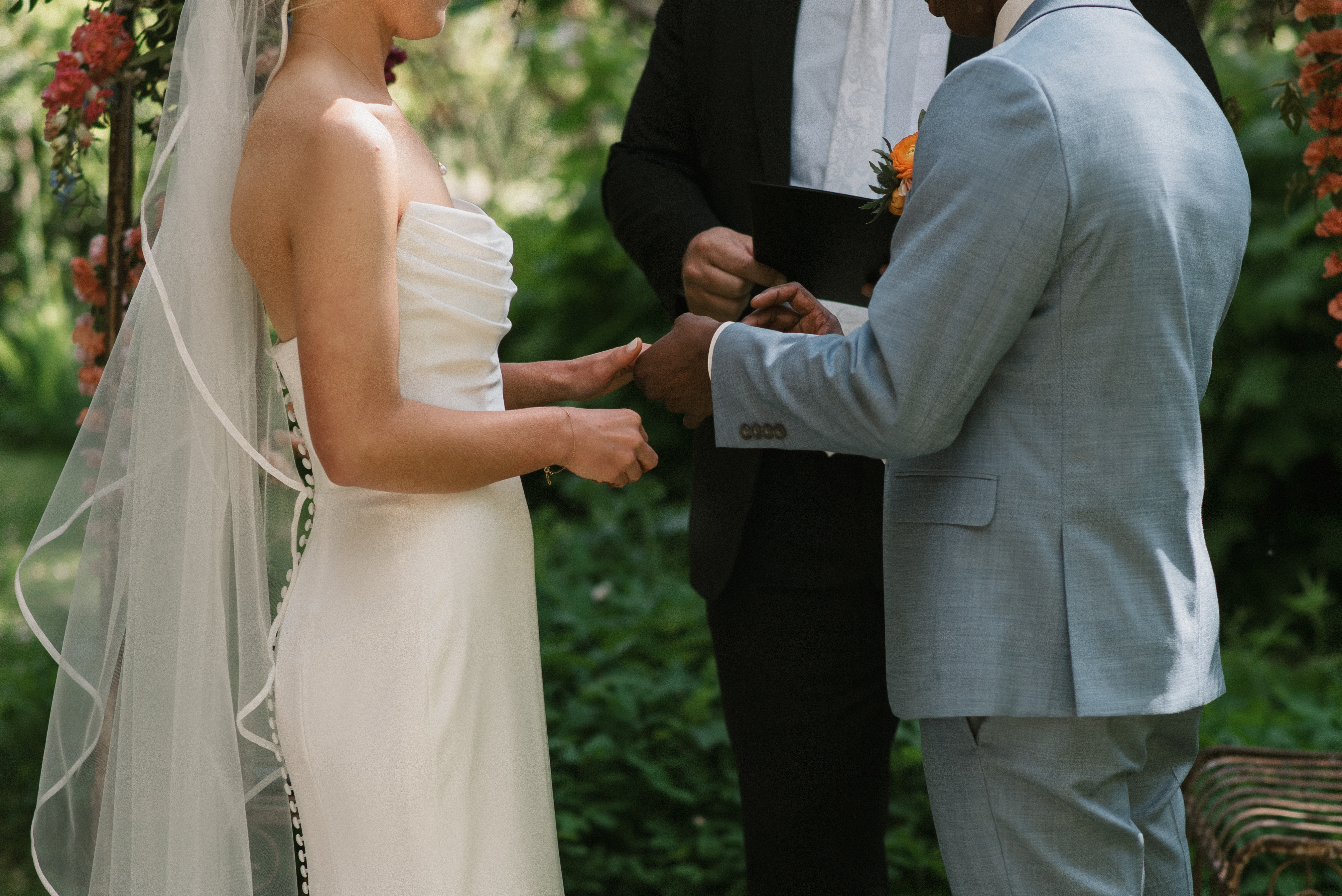 groom putting on the bride's wedding band