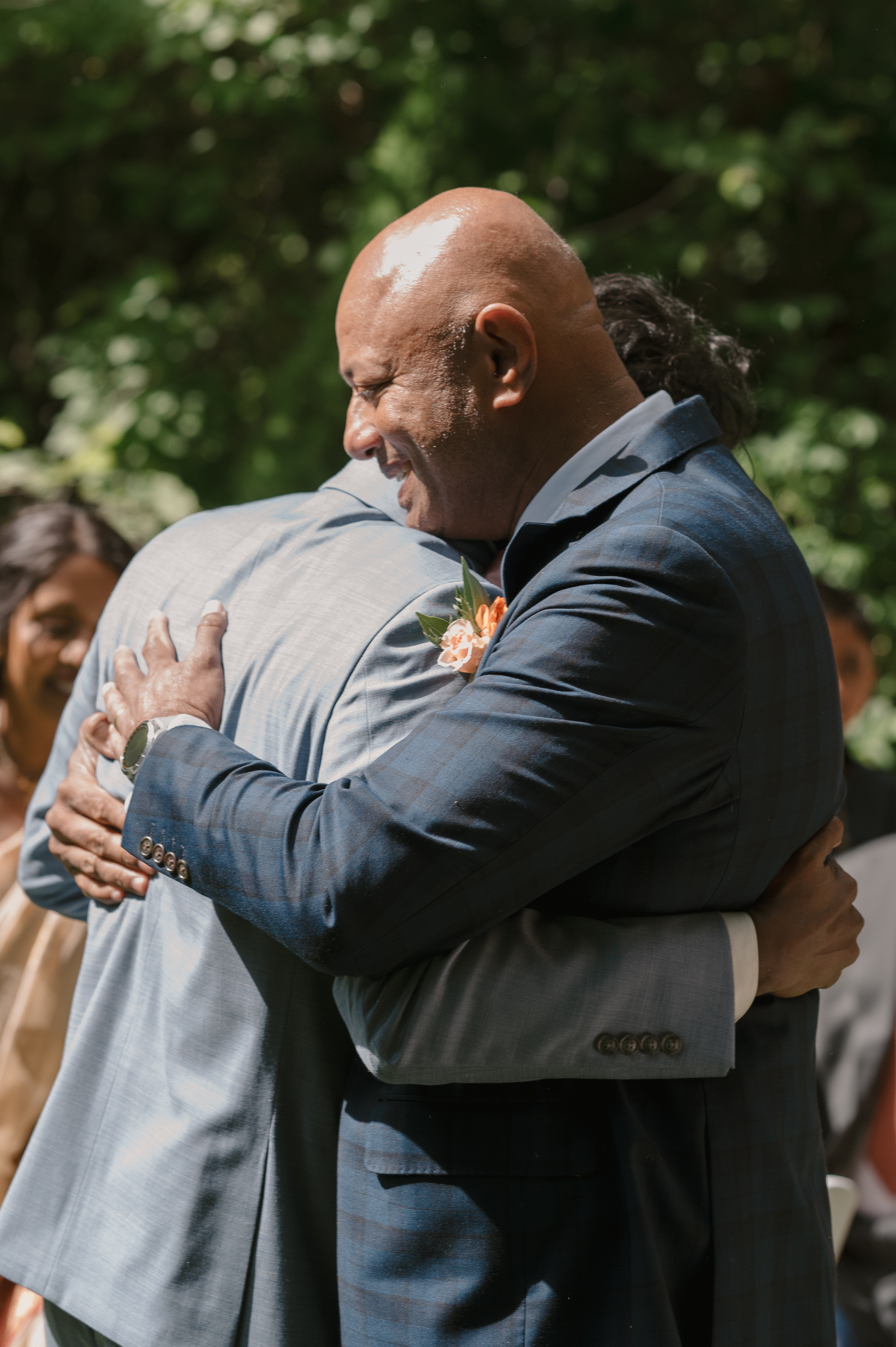 groom hugging his father after they walked down the isle together