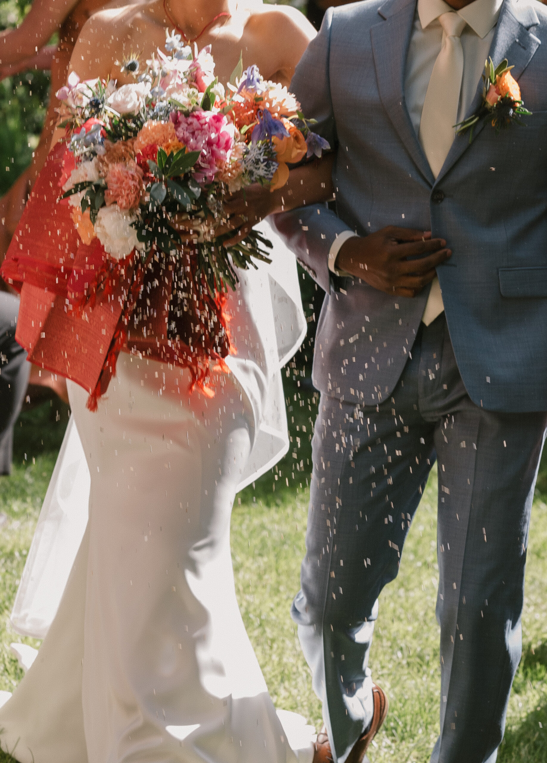 close up of lavender seeds being tossed at the bride and groom