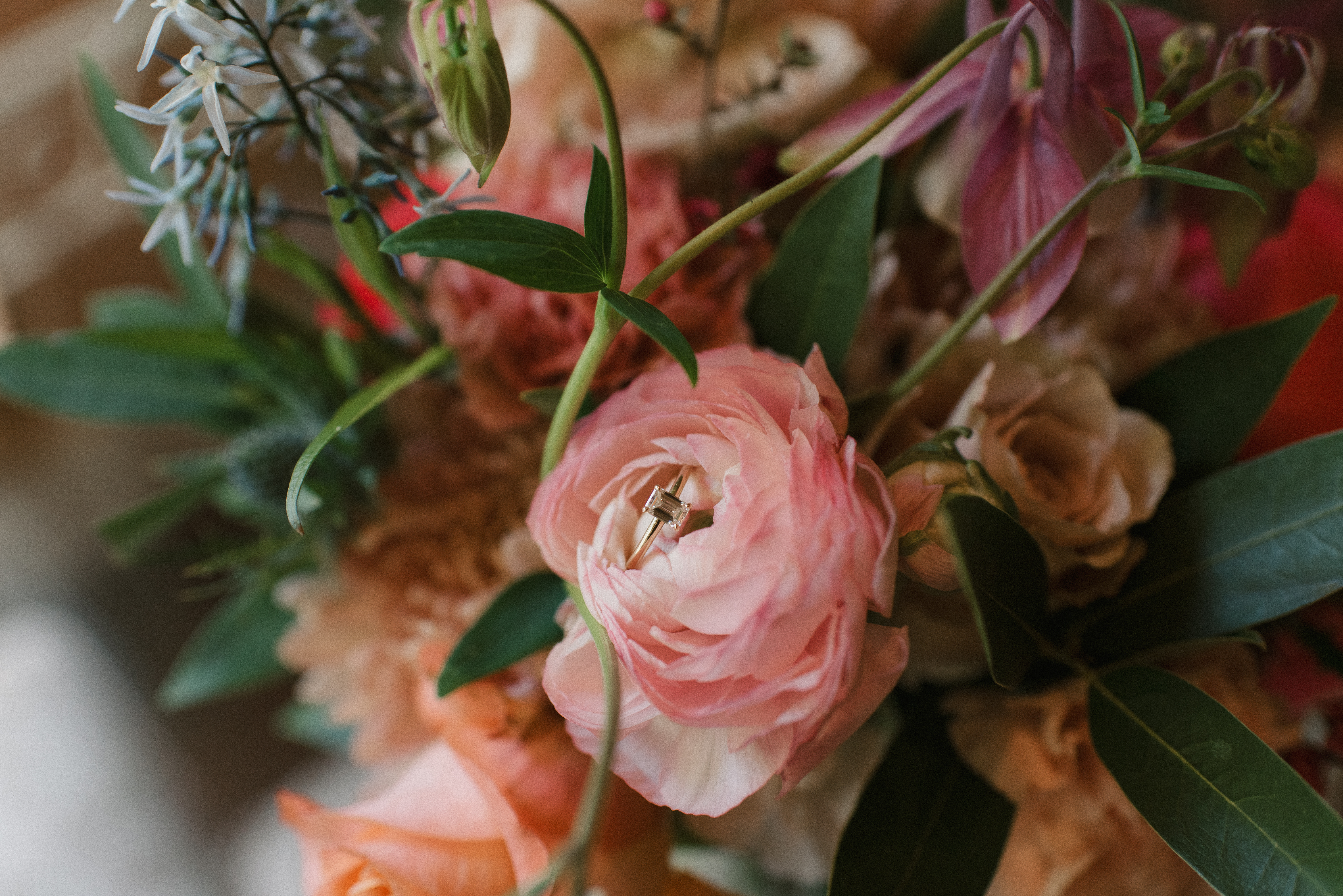 close up of wedding ring in wedding bouquet