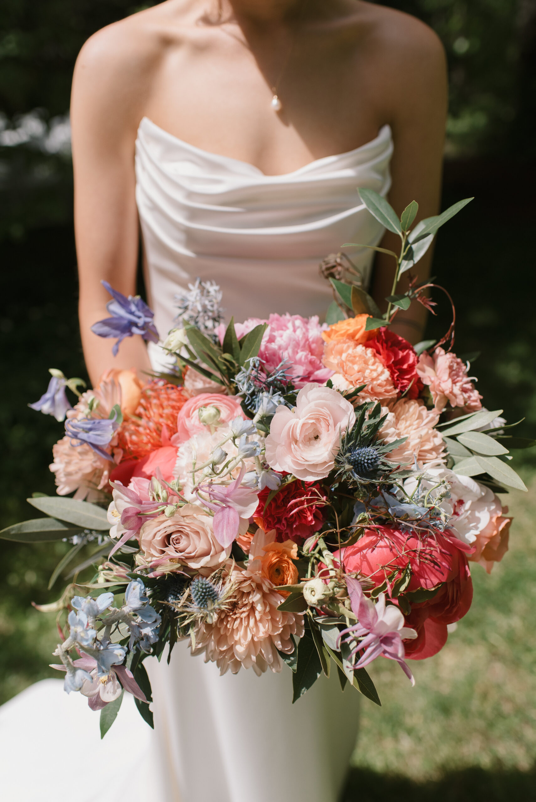 bride holding her colorful bouquet