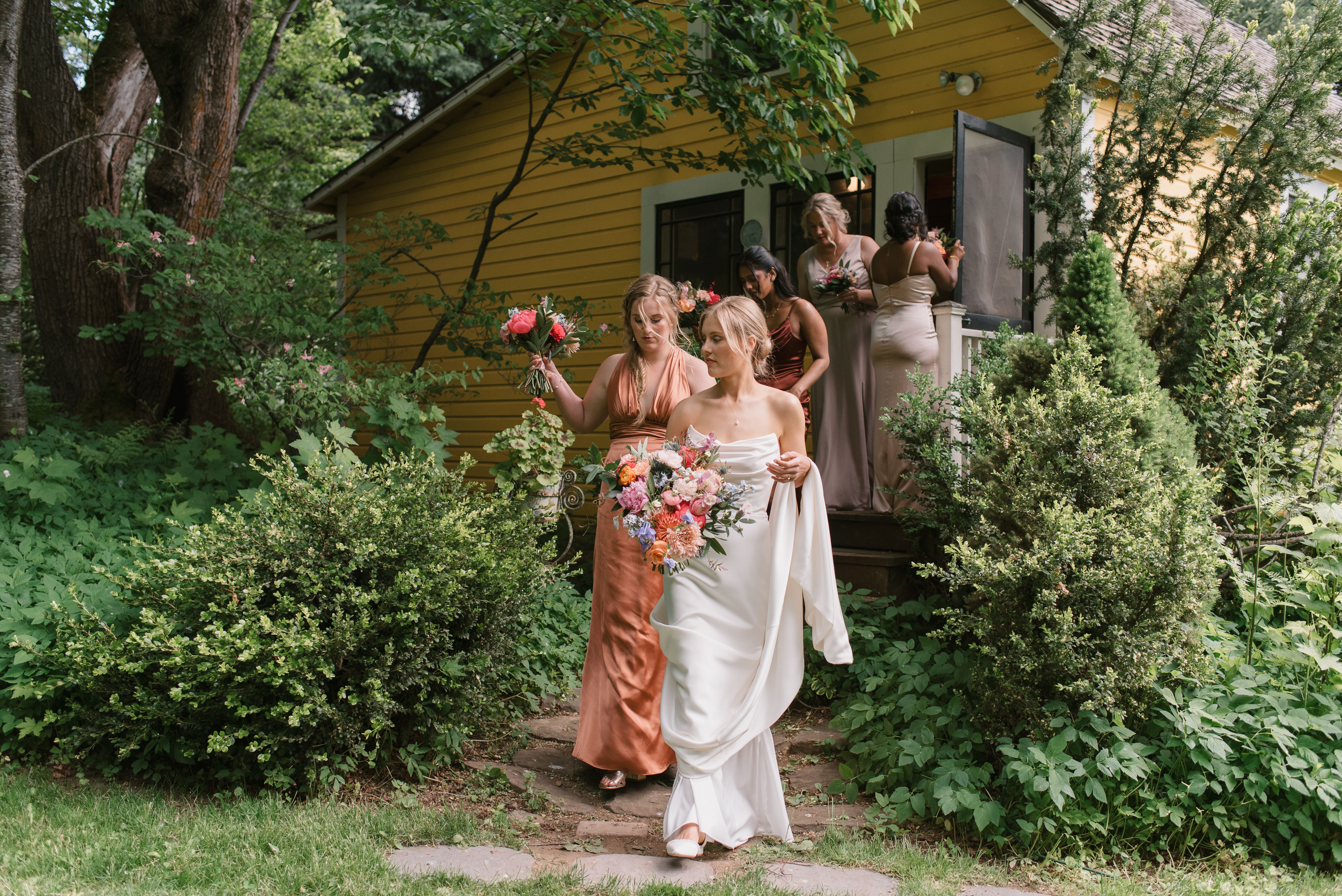 bride leading her bridesmaids out of the building at a Mt Hood Organic Farms Wedding