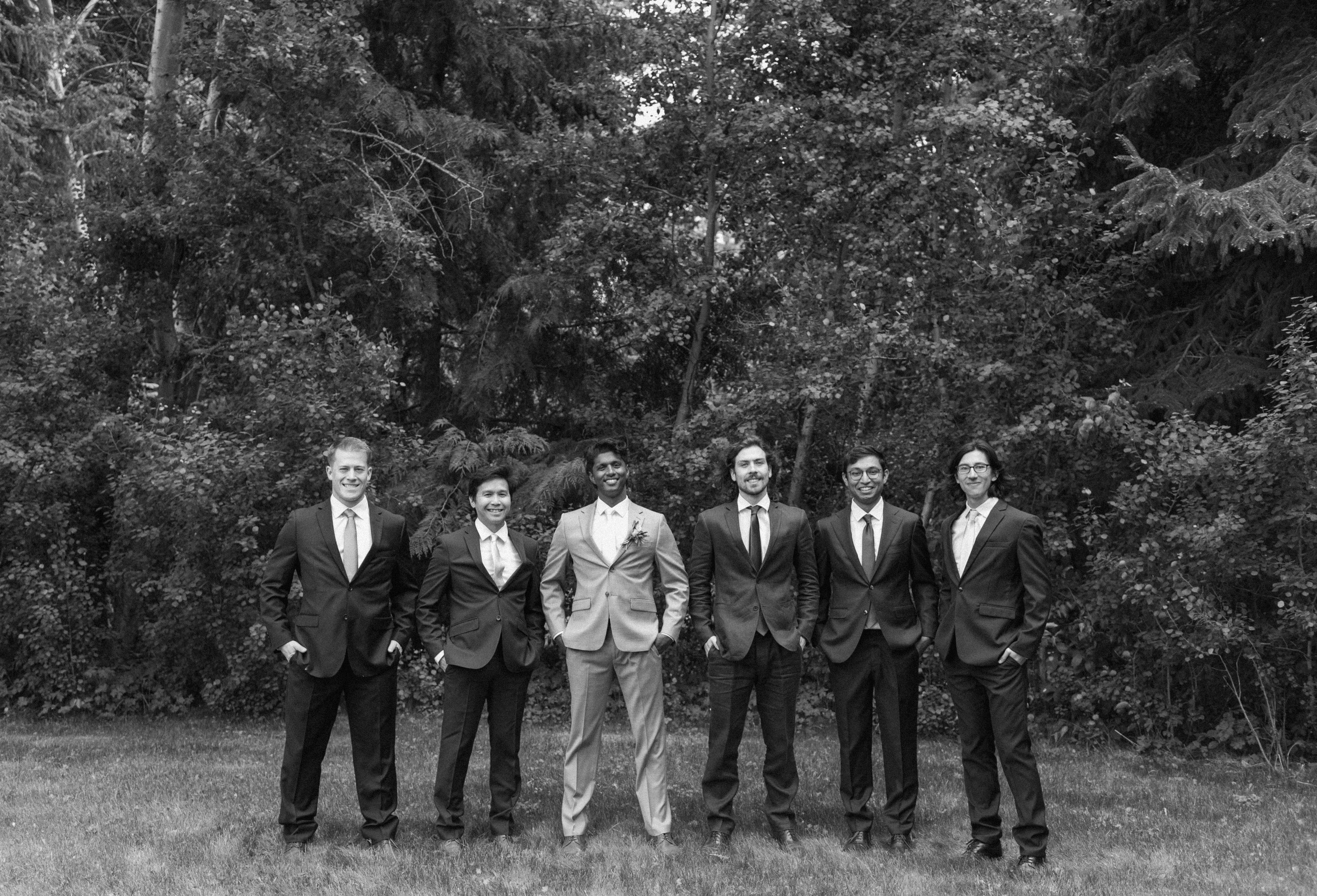 black and white photo of groom with groomsmen