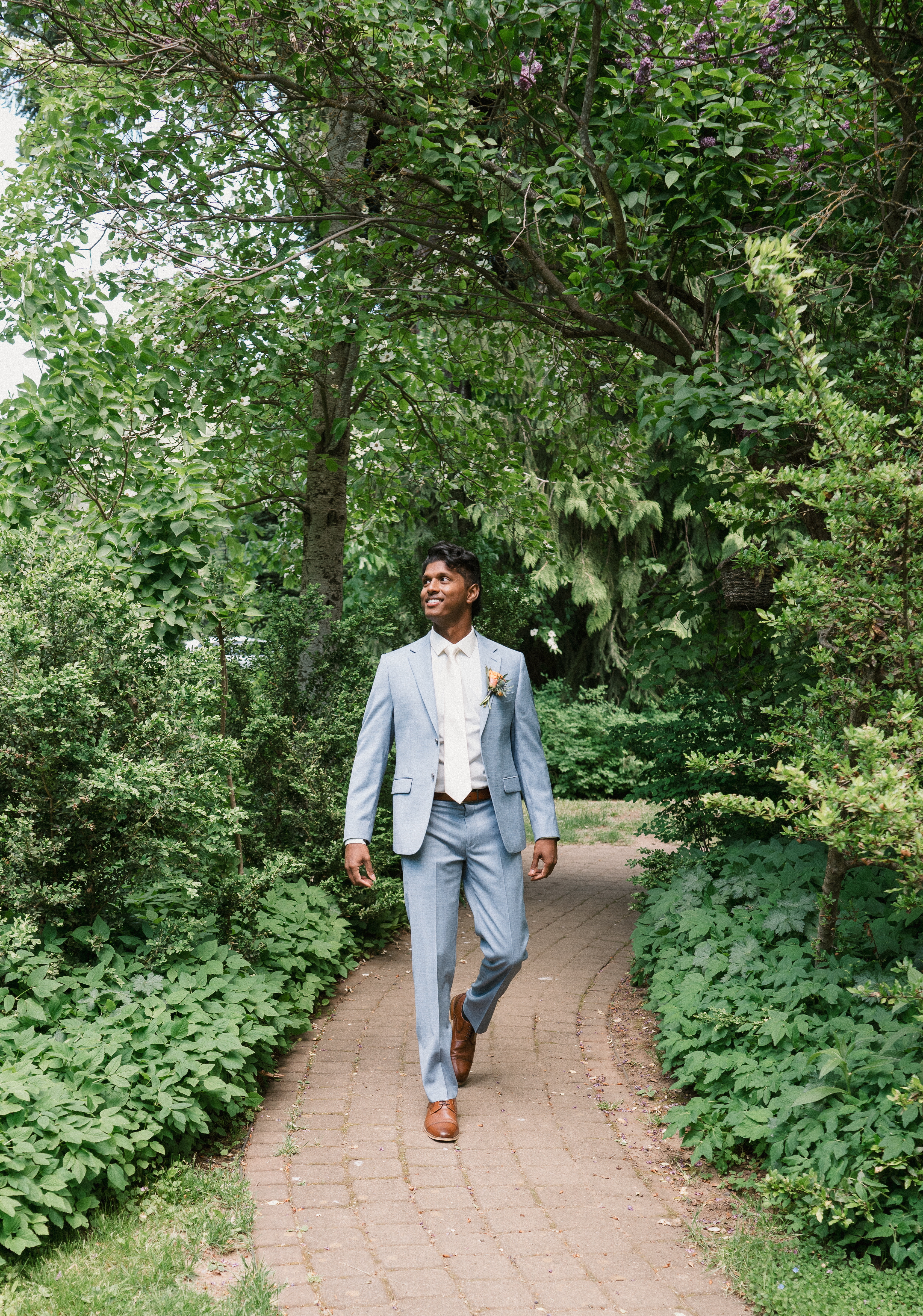 groom walking down a brick path at mt hood organic farms