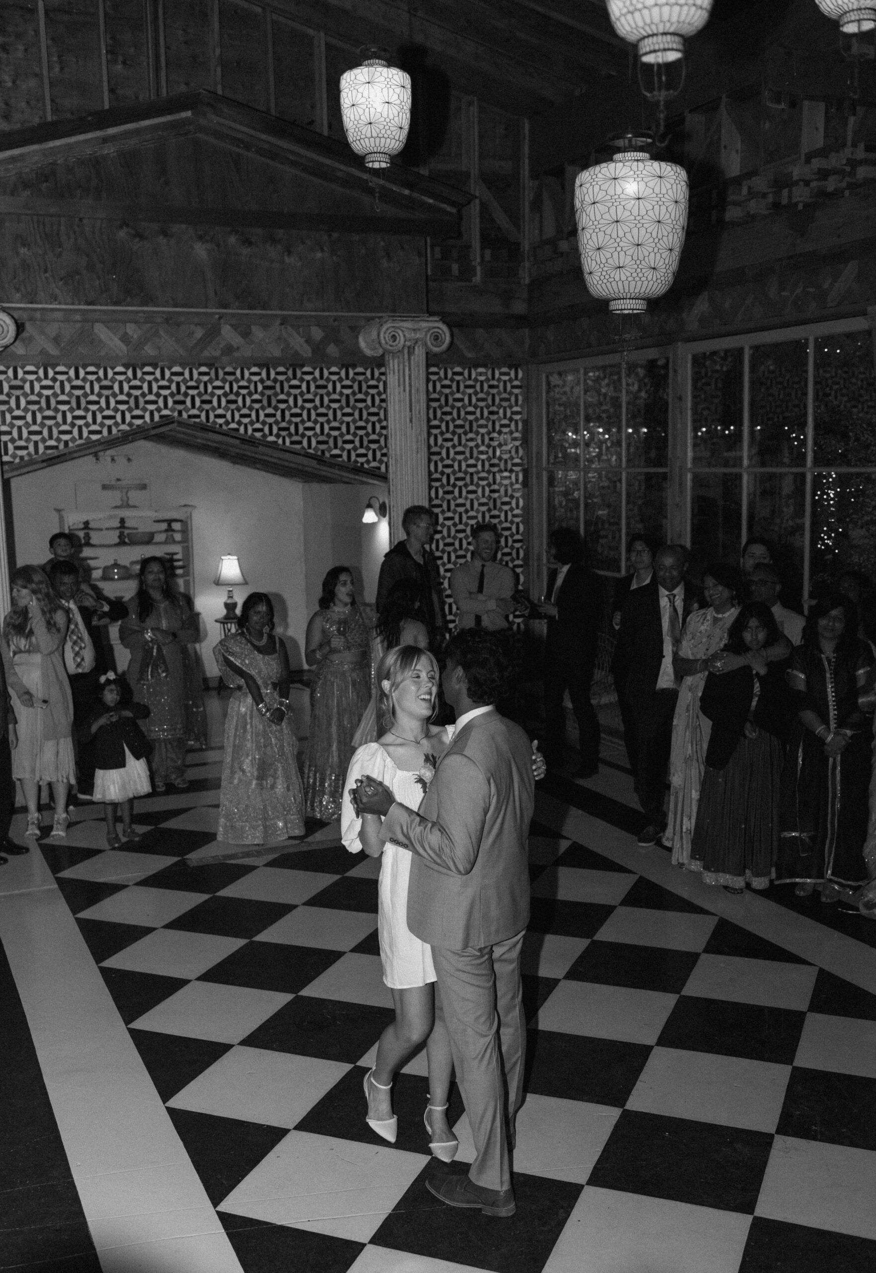 black and white photo of bride and groom having their first dance