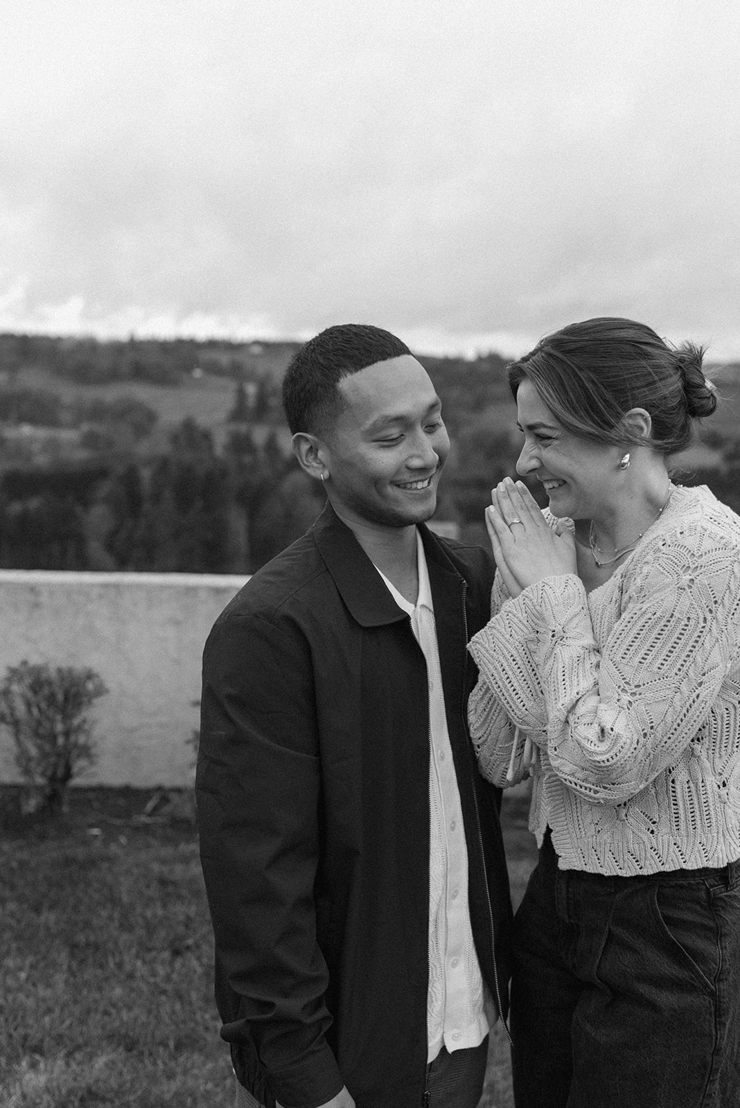 black and white of couple celebrating engagement