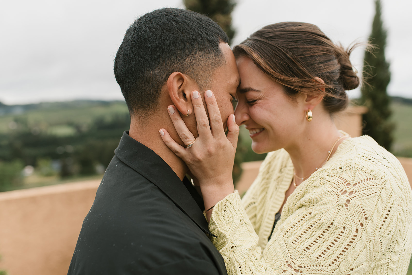 couple posing with heads together after newly getting engaged