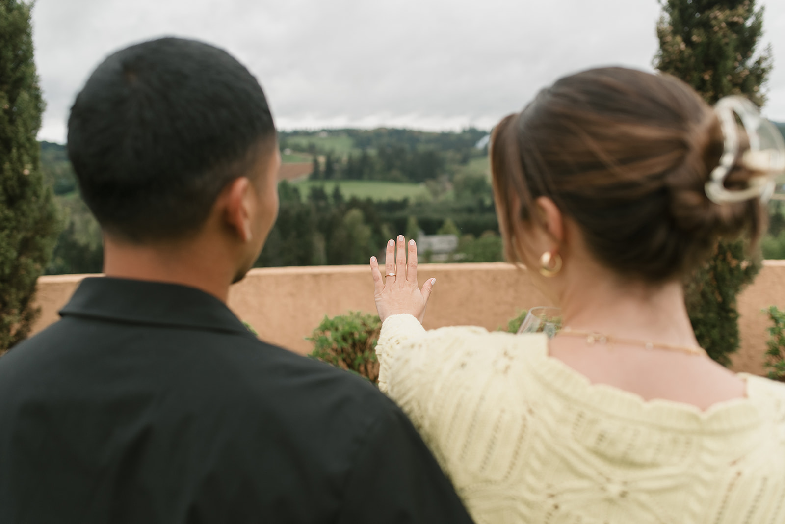 woman showing off her new ring to her fiance