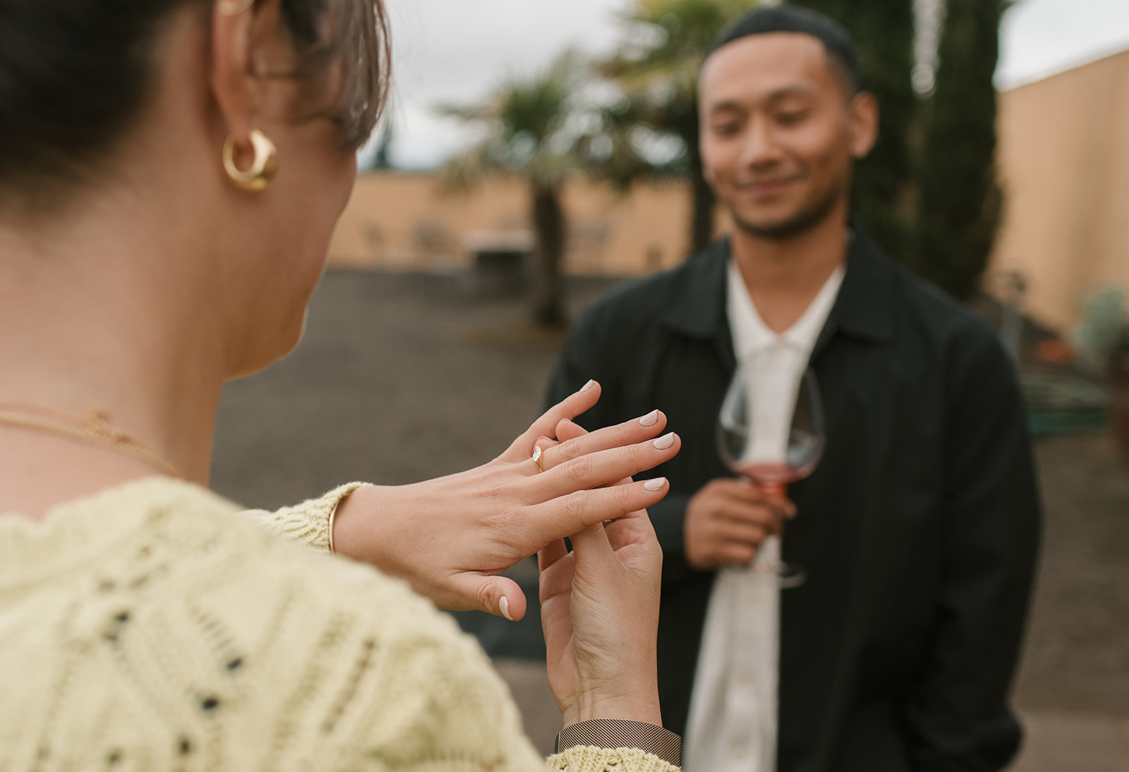 newly engaged woman looking at her engagement ring