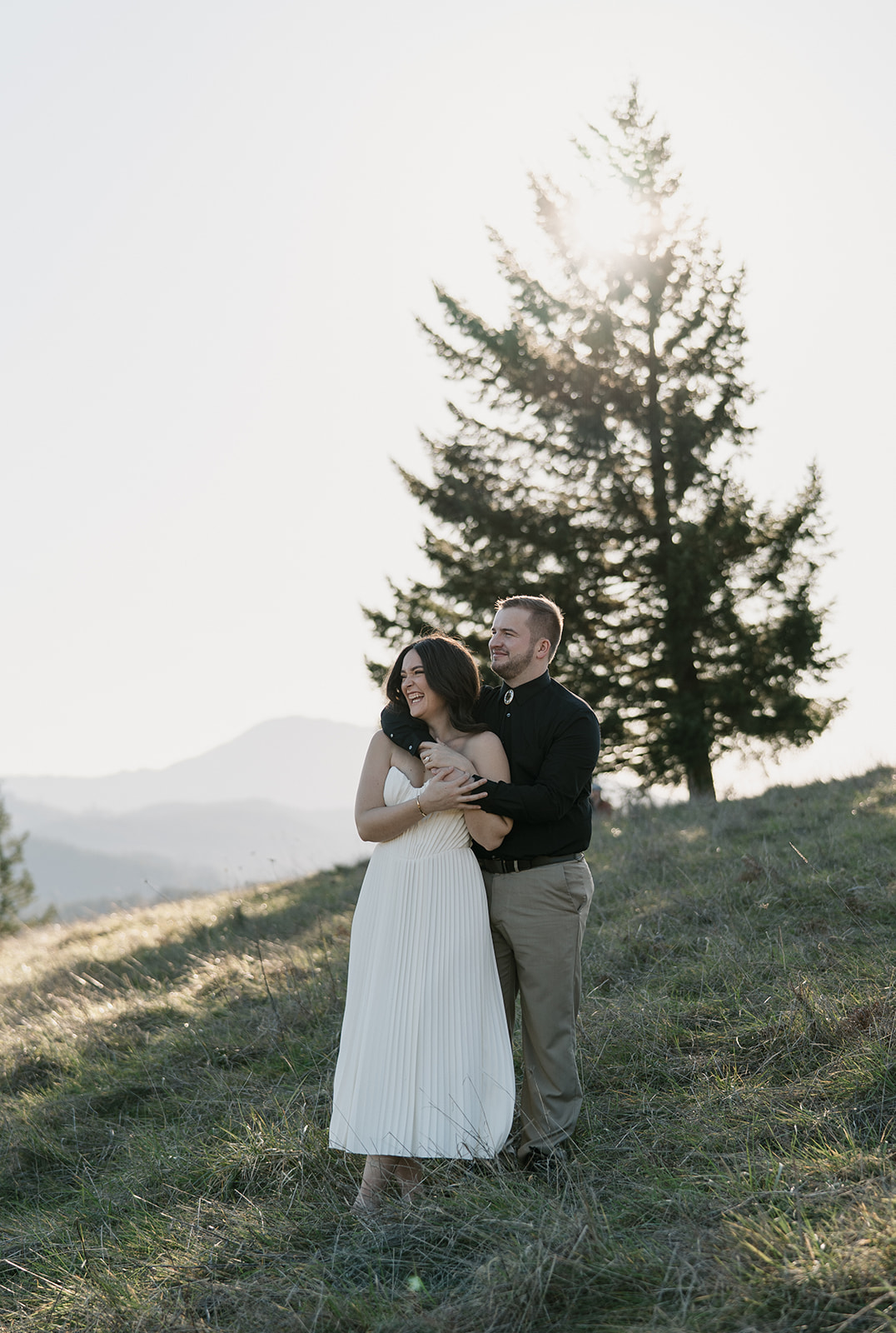 laughing couple in love on a mountaintop