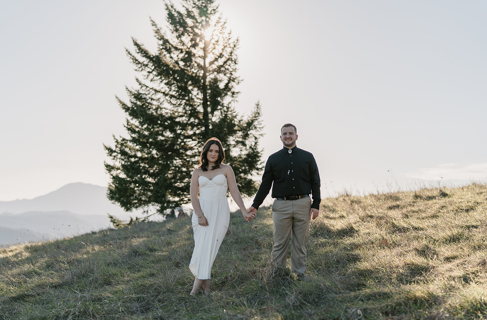 editorial pose of couple on a hillside