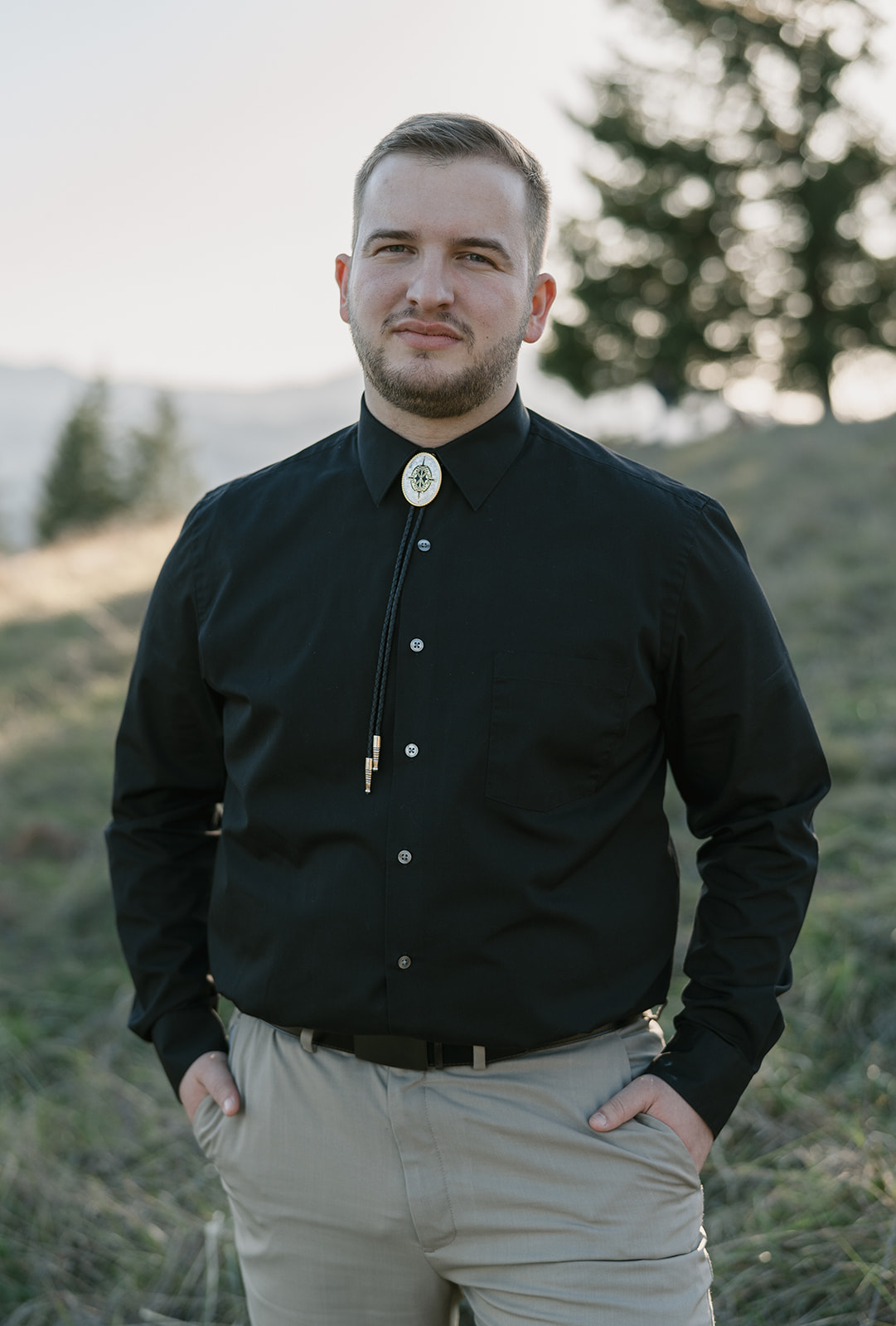 solo portrait of groom with bolo tie