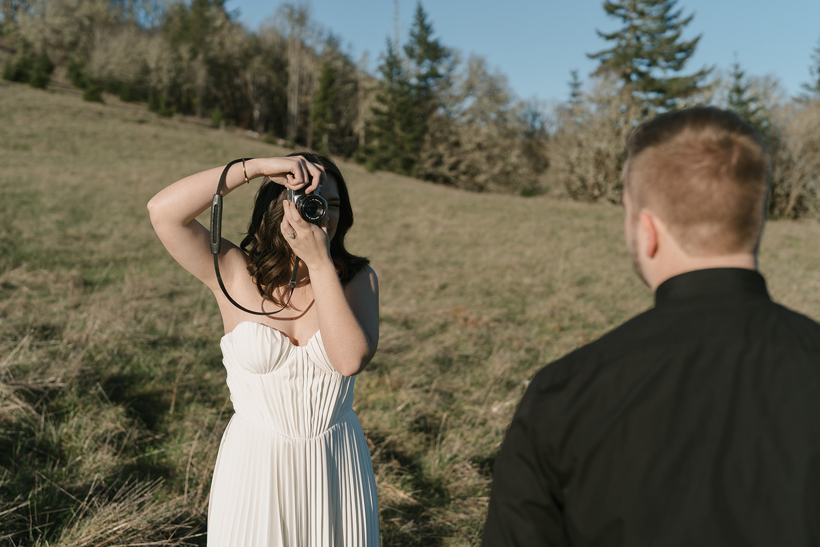 wedding photographer bride taking photo of her future groom