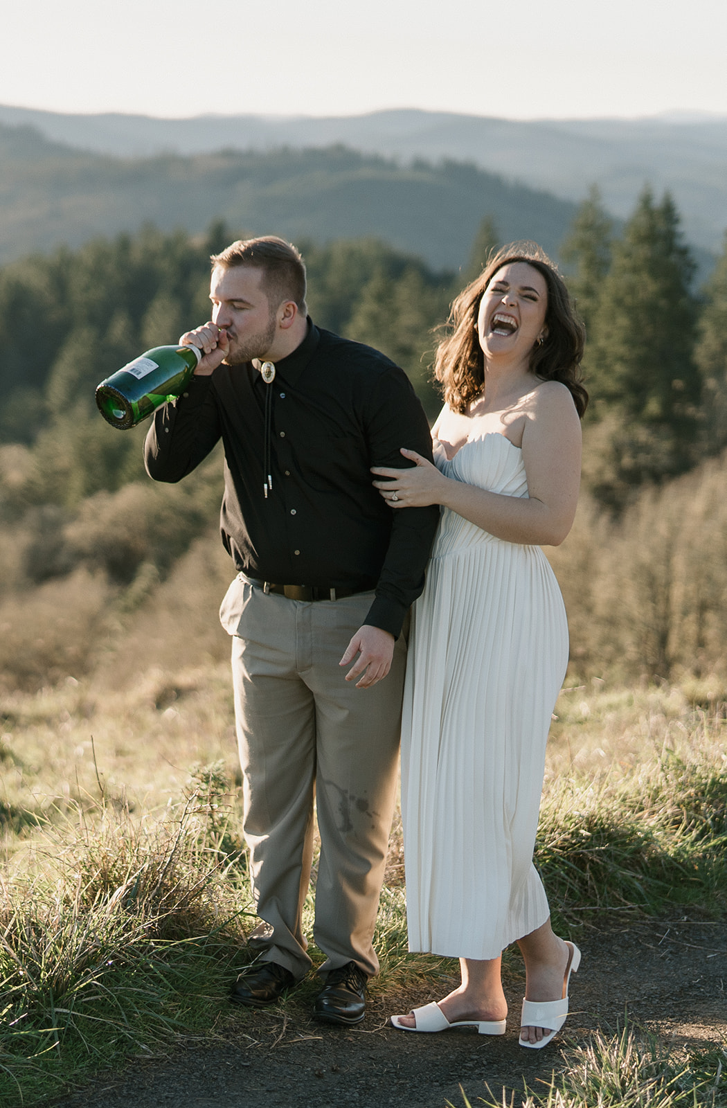 laughing champagne spray photo for engaged couple