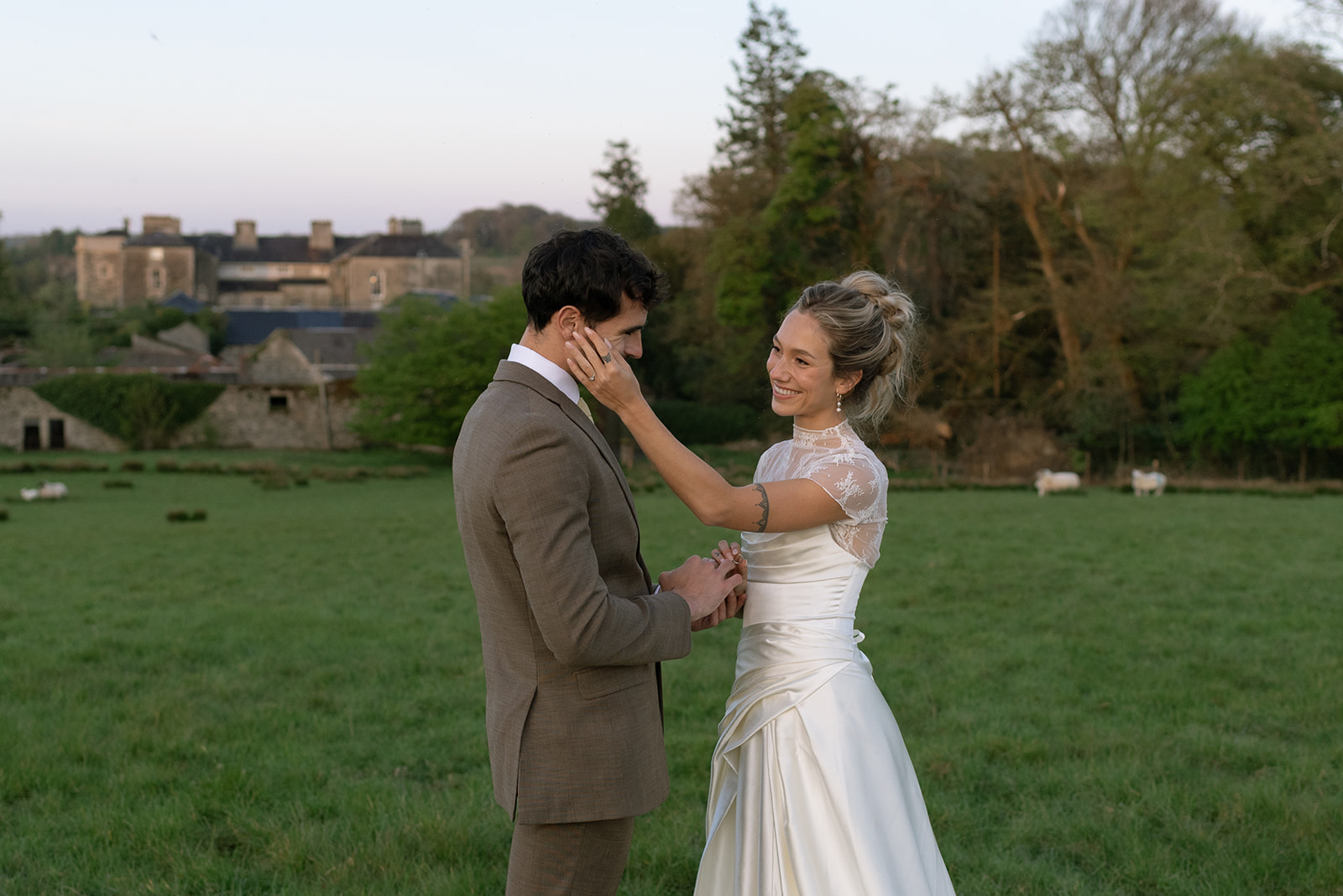 Couple exchanging vows under blue skies in Irish countryside, emotional Hilton Park Manor wedding moment