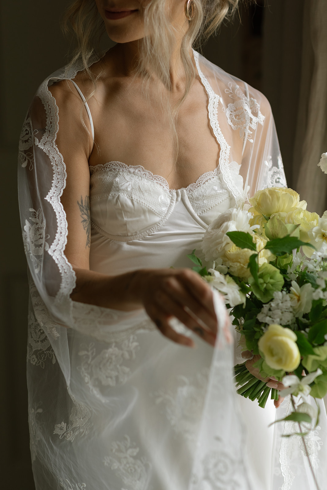 Close-up of bride holding bouquet with soft greenery and blush blooms, Ireland intimate wedding inspiration