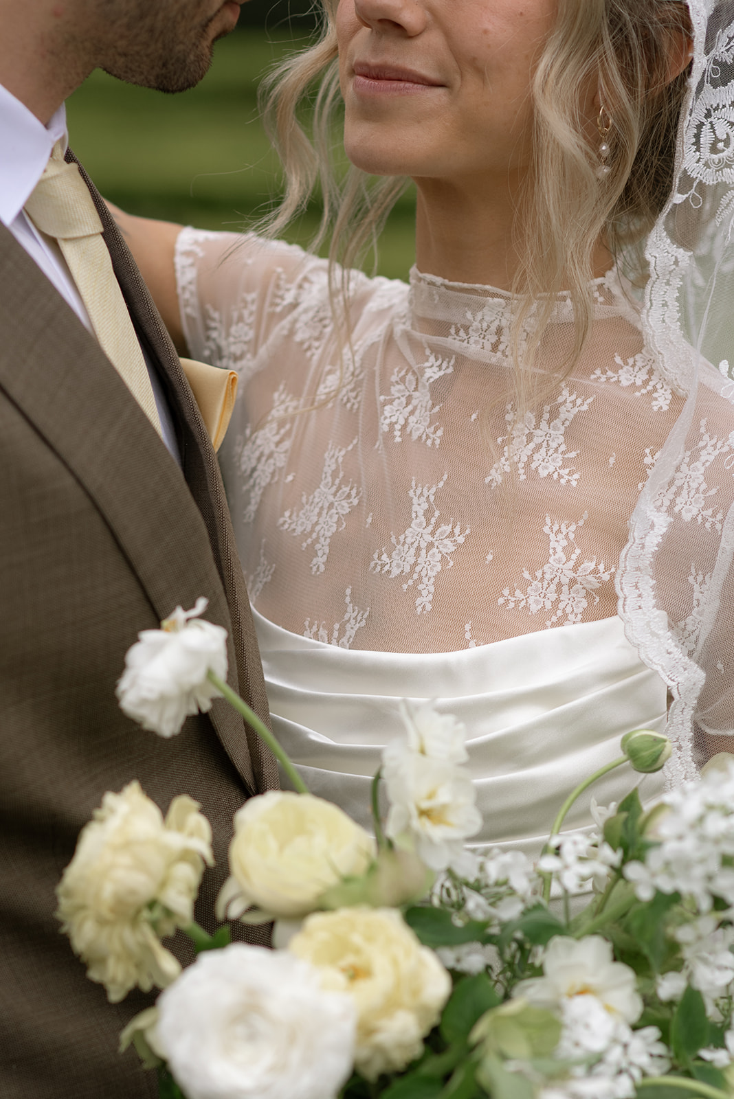Close-up of bride holding bouquet with soft greenery and blush blooms, Ireland intimate wedding inspiration
