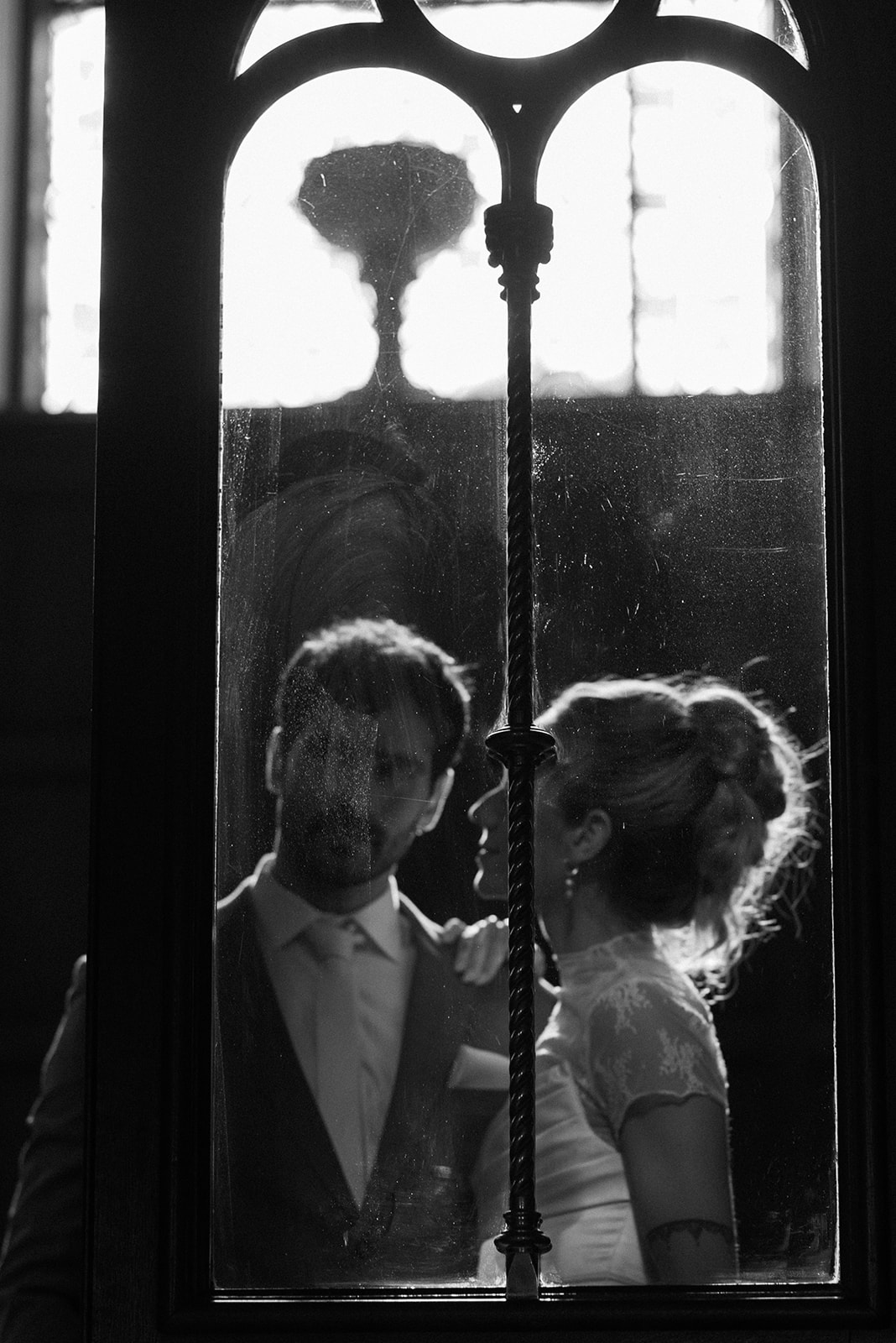 Couple standing in doorway of historic Irish manor, soft natural light and elegant architecture