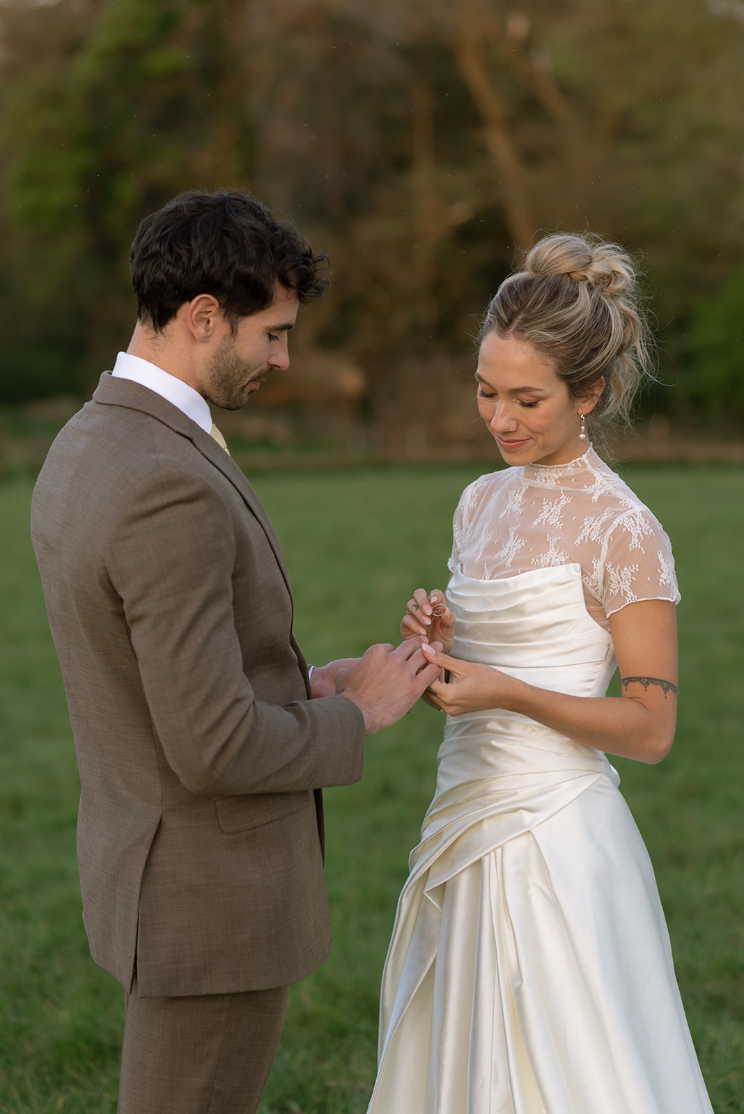 couple exchanging rings during golden hour in ireland