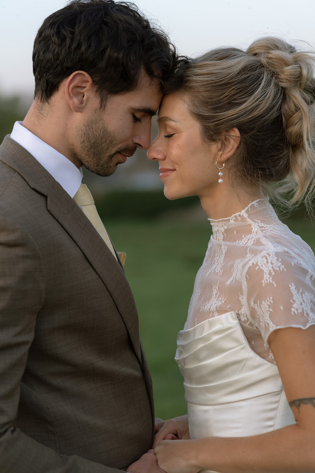 couple pressing their foreheads together during portraits on their wedding day
