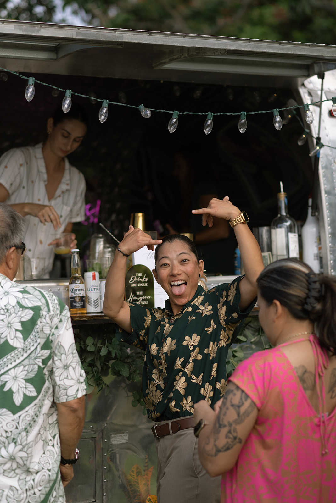 wedding guest smiling and signing "hang loose" to the camera
