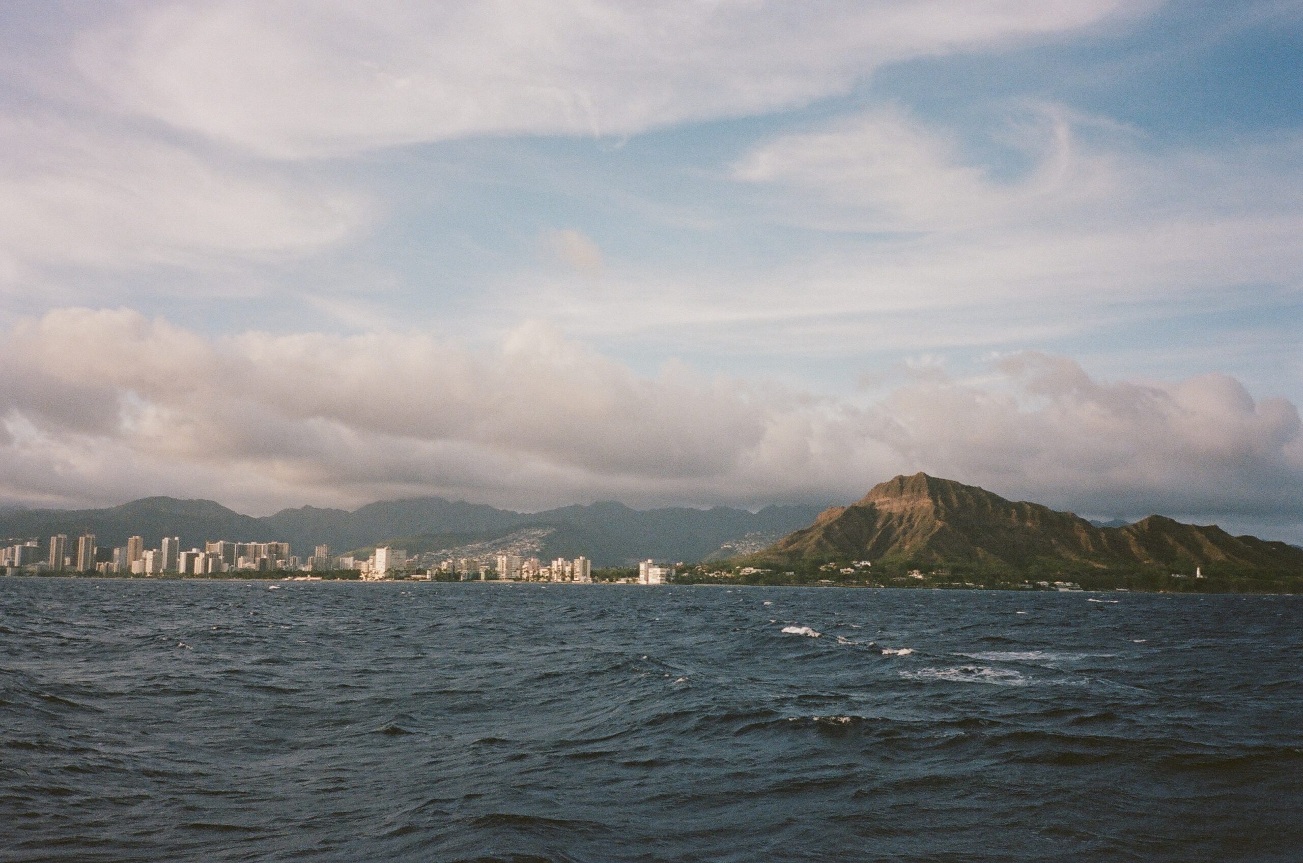 film photo of waikiki beach from a boat in the pacific ocean taken by a destination oahu wedding photographer